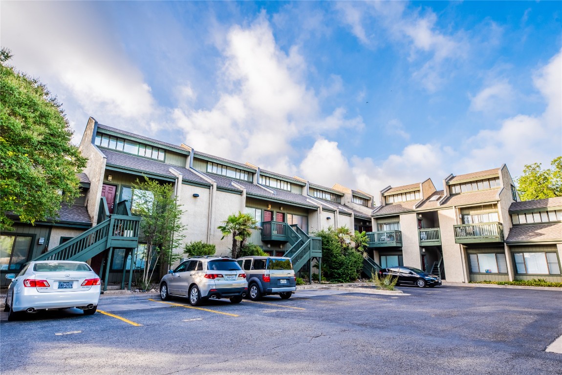 601 Nelray Boulevard, Unit 5 Austin, TX 78751 - Photo 2 of 13 View of building exterior featuring stairs and uncovered parking