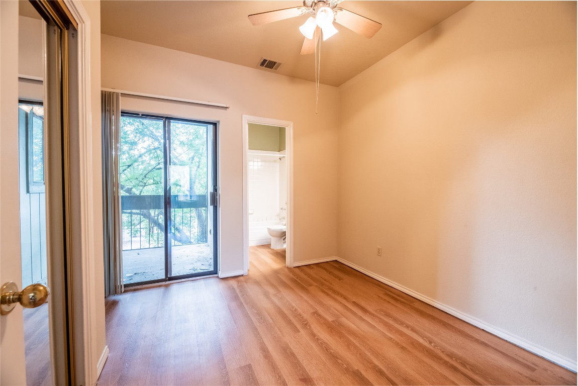 601 Nelray Boulevard, Unit 5 Austin, TX 78751 - Photo 6 of 13 Unfurnished room featuring light wood-style floors and a ceiling fan