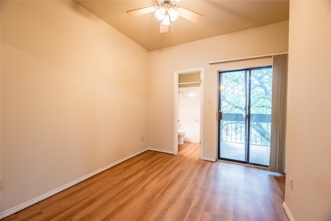 601 Nelray Boulevard, Unit 5 Austin, TX 78751 - Photo 7 of 13 Unfurnished room featuring light wood finished floors and ceiling fan