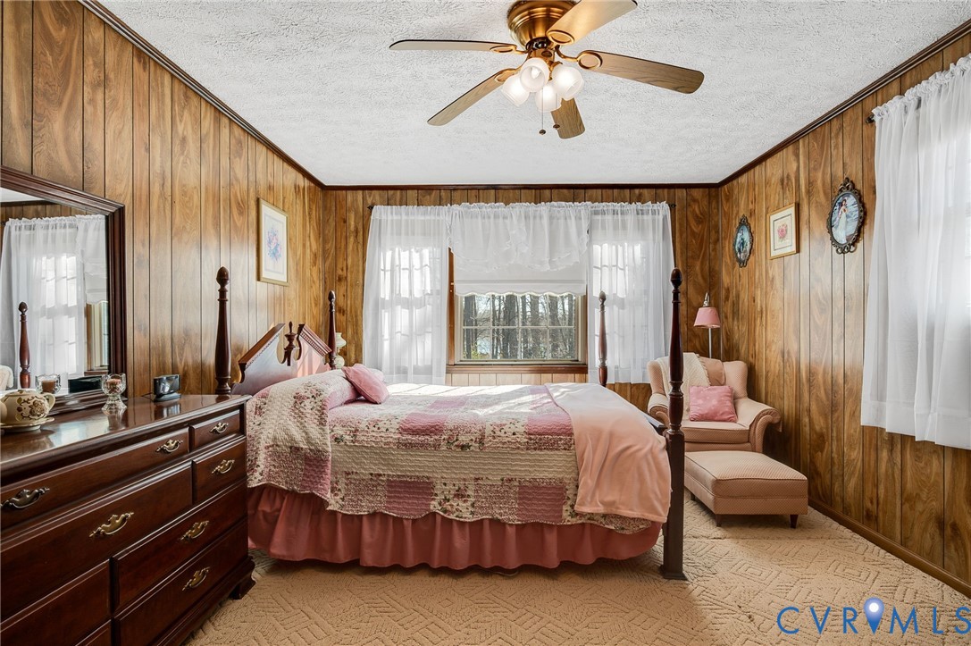 475 Dove Road Boydton, VA 23917 - Photo 22 of 45 a bedroom with a bed chandelier and a window