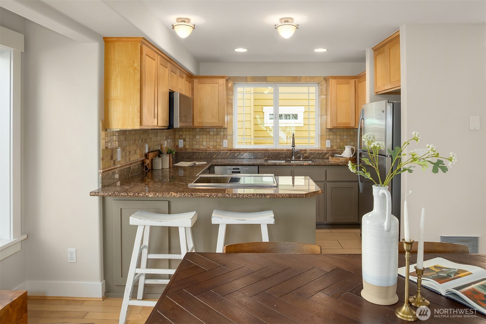 739 North 94th Street, Unit B Seattle, WA 98103 - Photo 11 of 39 a kitchen with a sink appliances cabinets and dining table