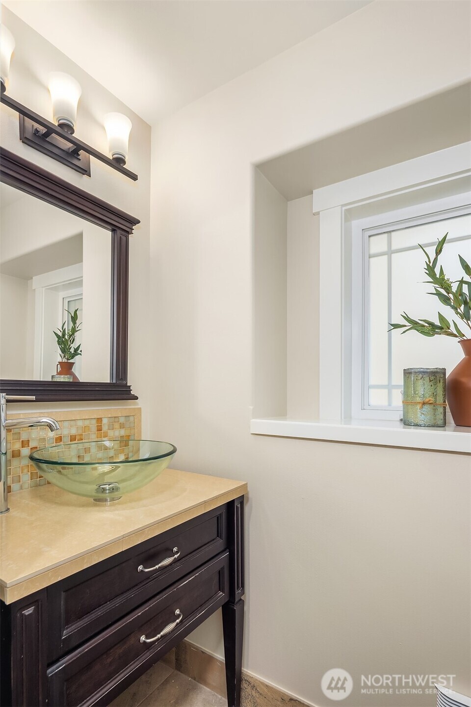 739 North 94th Street, Unit B Seattle, WA 98103 - Photo 24 of 39 a bathroom with a sink a mirror and a window