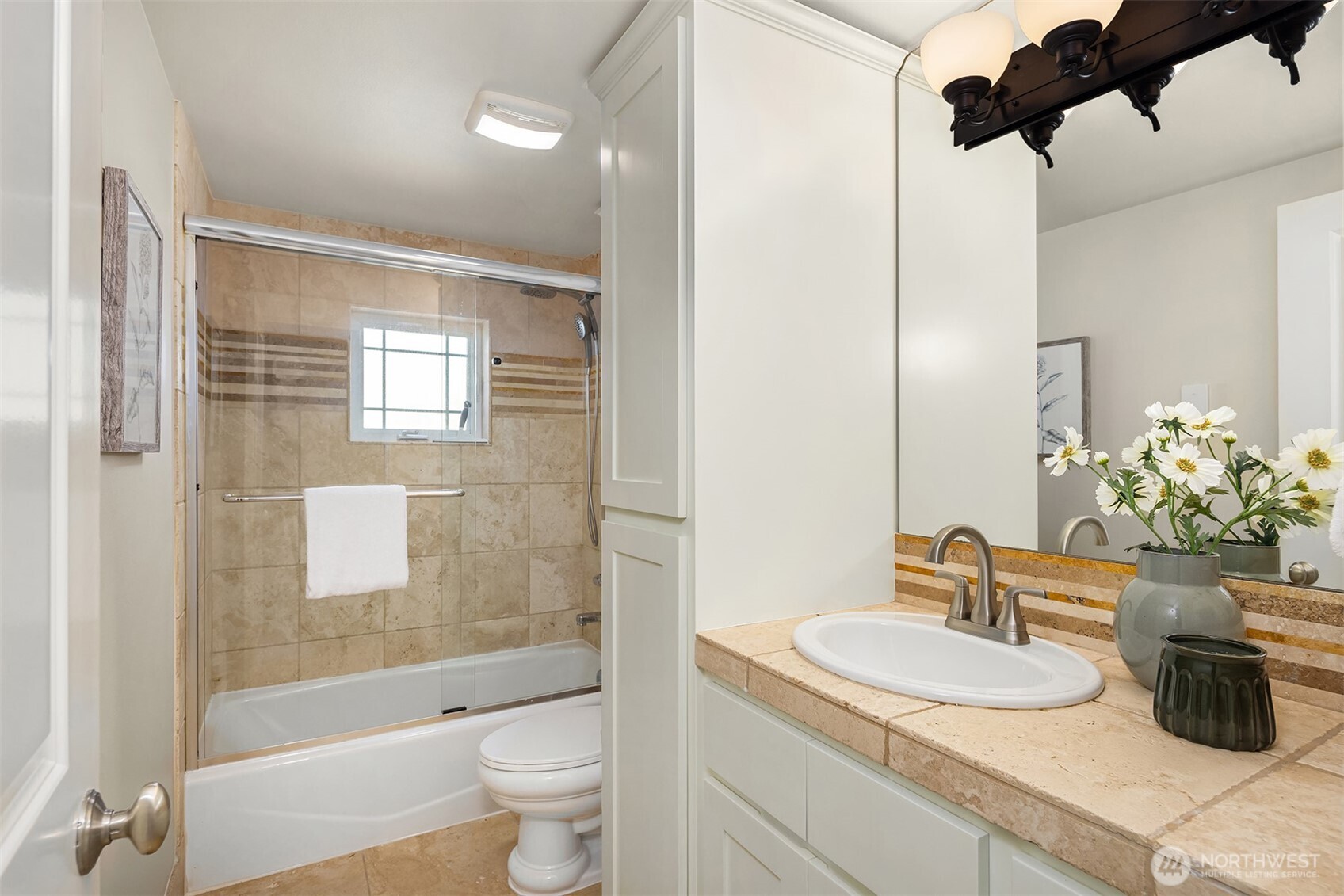 739 North 94th Street, Unit B Seattle, WA 98103 - Photo 29 of 39 a bathroom with a granite countertop sink a toilet a mirror and shower