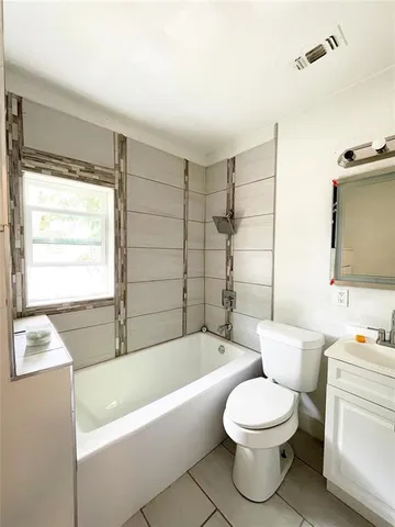 a bathroom with a toilet a sink and bathtub