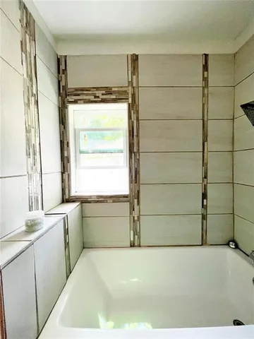 a bathroom with a bathtub and a sink