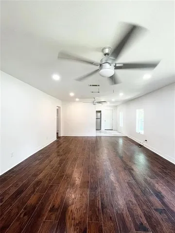 a view of an empty room and wooden floor
