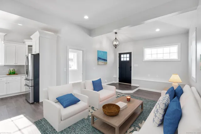 a open kitchen with white cabinets and stainless steel appliances