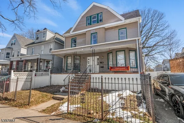 a view of a brick house with many windows