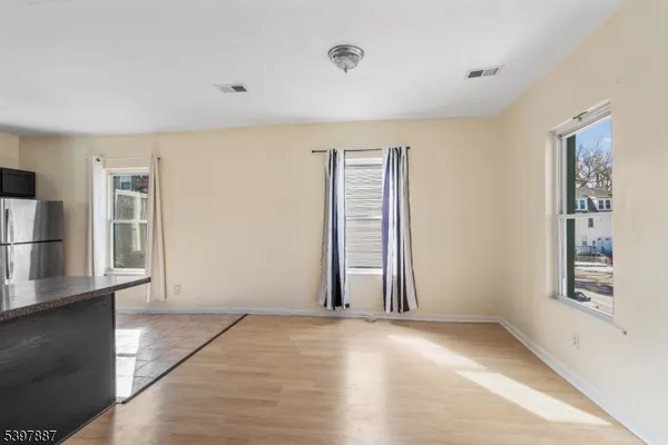 an empty room with windows and closet