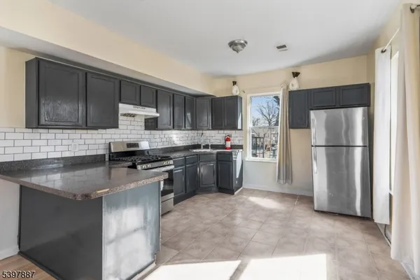 a kitchen with a refrigerator sink and microwave