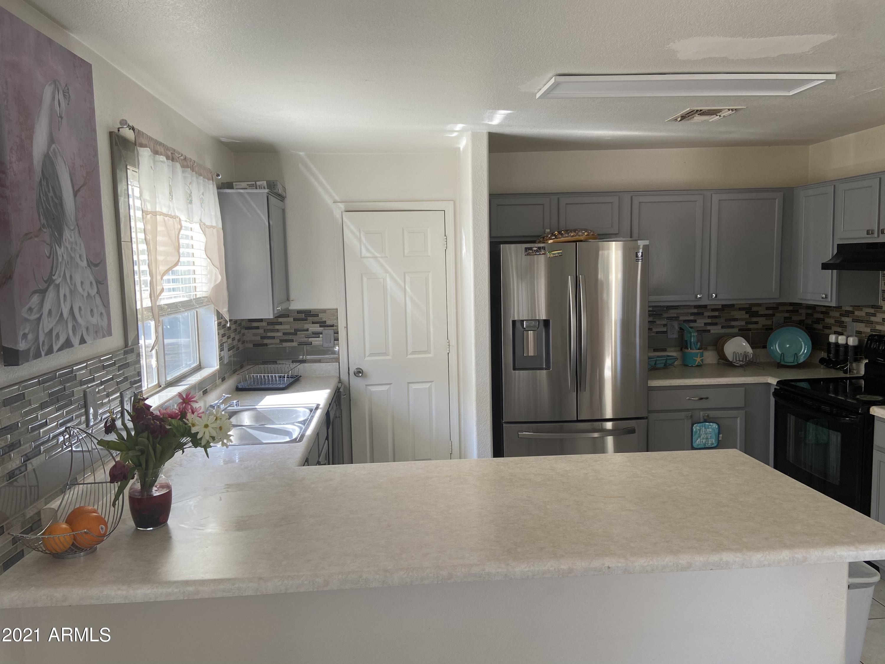 12701 West Hearn Road El Mirage, AZ 85335 - Photo 4 of 15 EE2EEA8A-A1EB-4AF2-BBB9-A0C7774A61BA