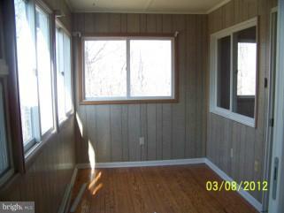 307 Farm Ridge Road Front Royal, VA 22630 - Photo 8 of 19 a view of a hallway with wooden floor and a window