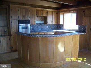 307 Farm Ridge Road Front Royal, VA 22630 - Photo 10 of 19 a kitchen with kitchen island granite countertop cabinets and window