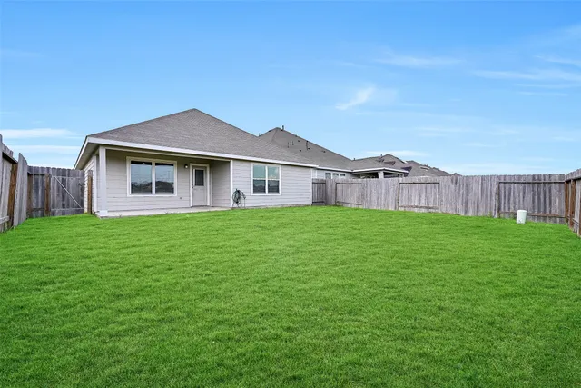 a front view of a house with a garden and yard