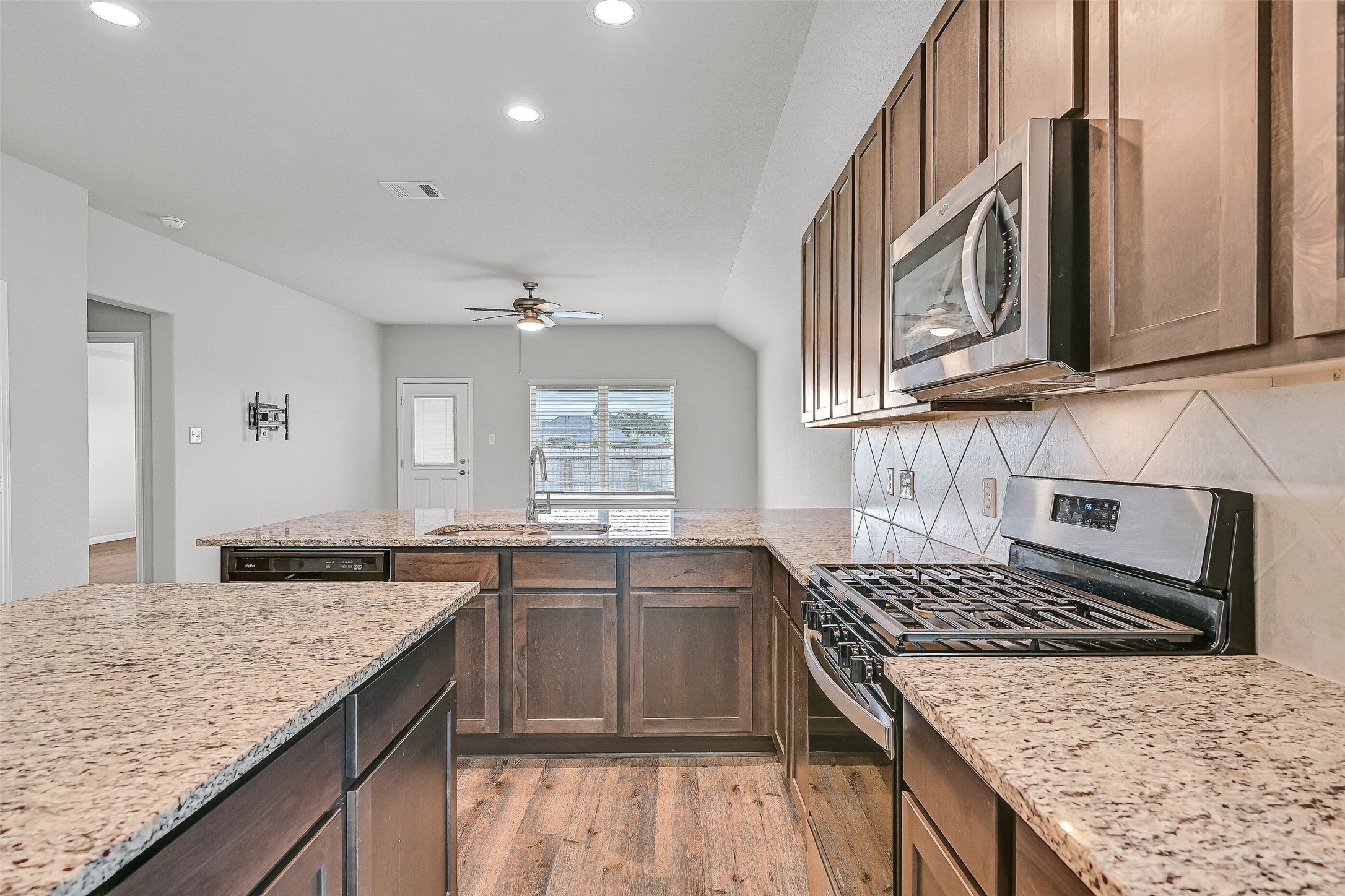 5407 James Michael Drive Rosharon, TX 77583 - Photo 8 of 32 a kitchen with granite countertop a sink stove and cabinets