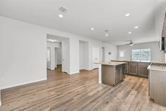 a view of kitchen with granite countertop cabinets and wooden floor
