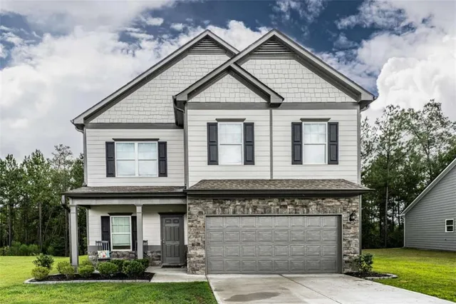 a front view of a house with garden