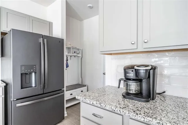 a kitchen with granite countertop stainless steel appliances and a counter space