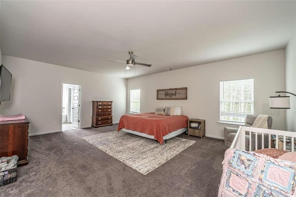 84 Royal Oaks Drive Rome, GA 30165 - Photo 13 of 27 a spacious bedroom with a bed a window and dresser