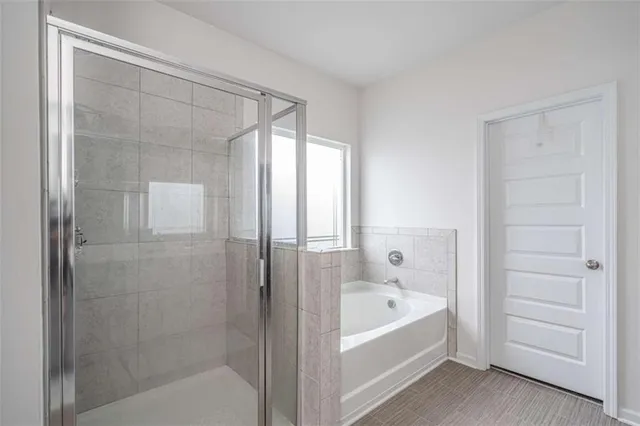 a bathroom with a bathtub and a shower