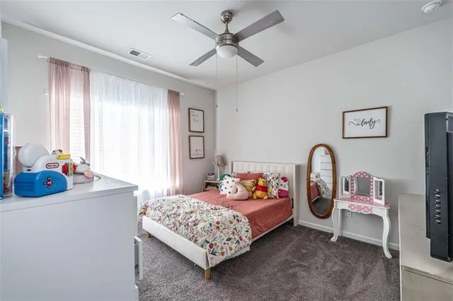 a bedroom with bed and a chandelier