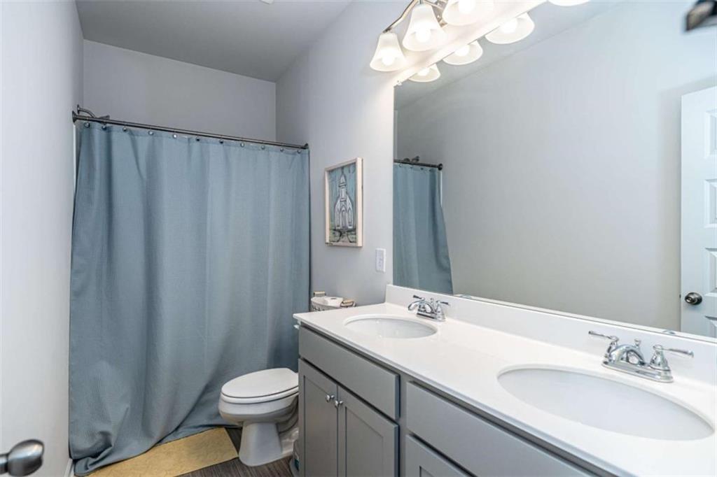 84 Royal Oaks Drive Rome, GA 30165 - Photo 19 of 27 a bathroom with a sink a toilet and a mirror