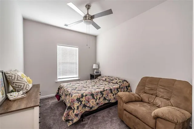 a bedroom with bed couch and window