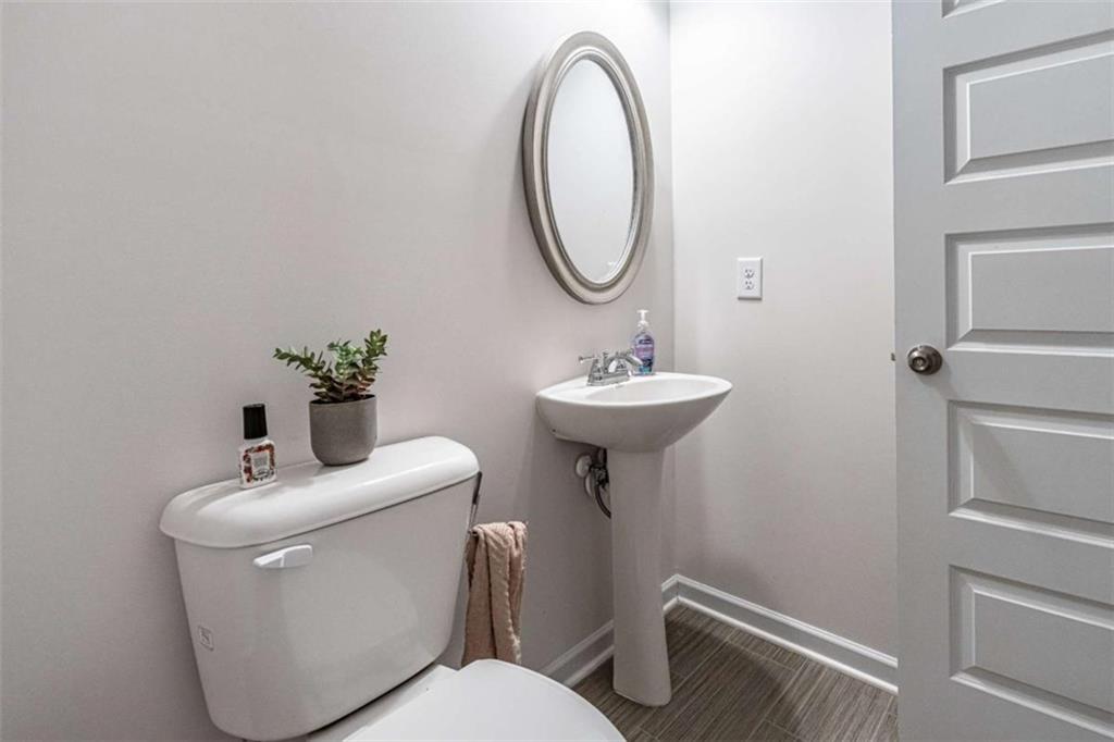 84 Royal Oaks Drive Rome, GA 30165 - Photo 25 of 27 a bathroom with a toilet sink and mirror