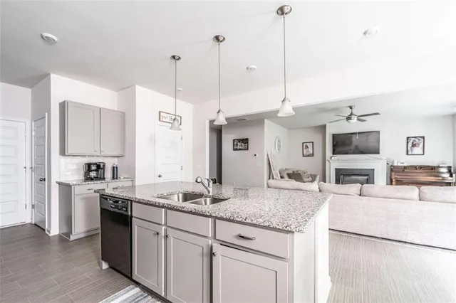 a kitchen with stainless steel appliances granite countertop a sink a stove and a refrigerator