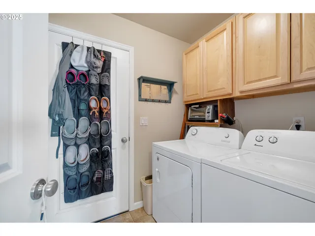 a utility room with dryer washer and other items