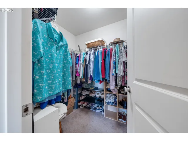 a view of a room with furniture and clothes