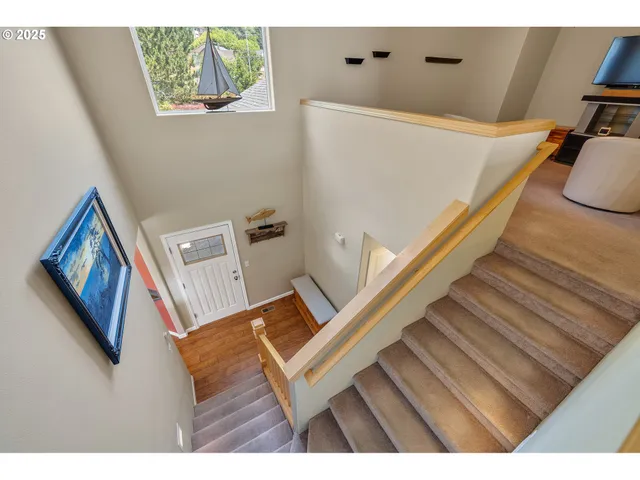 a view of a living room with furniture and a painting on the wall