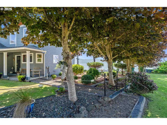 a view of a house with backyard sitting area and garden