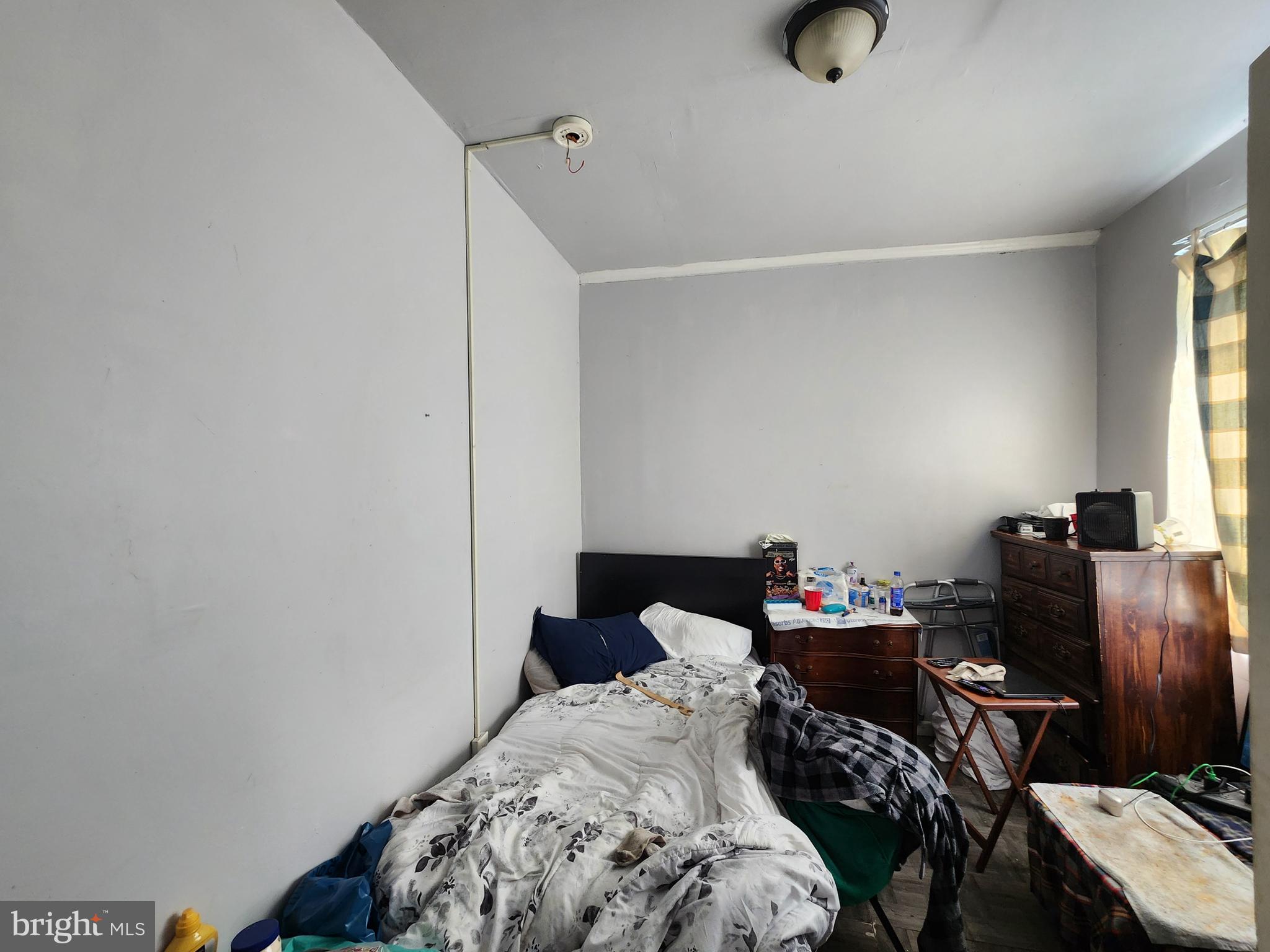 2217 Bryant Avenue Baltimore, MD 21217 - Photo 26 of 31 a bedroom with bed and a window