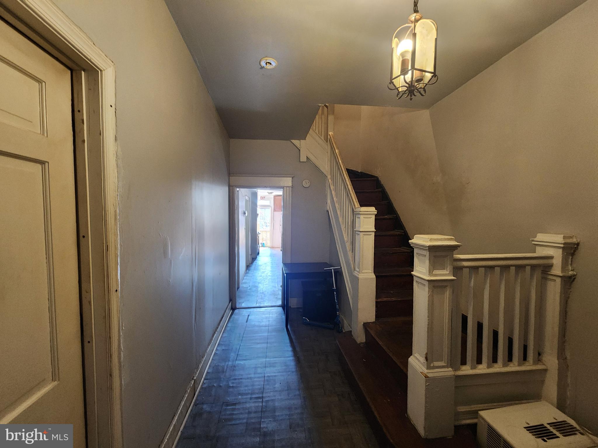 2217 Bryant Avenue Baltimore, MD 21217 - Photo 4 of 31 a view of a hallway with wooden floor and staircase