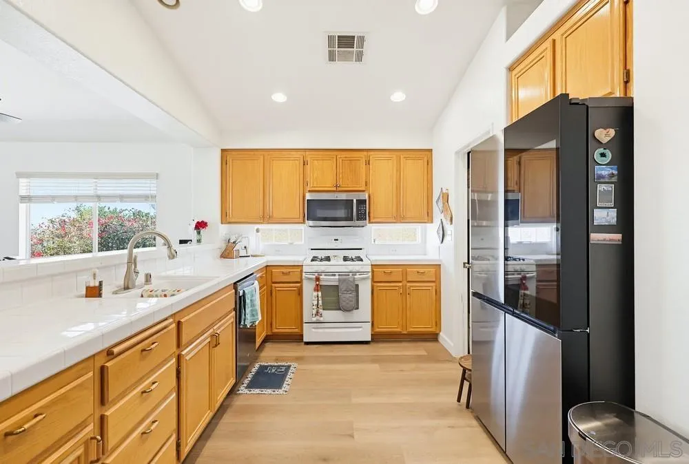 2501 Columbine Road Alpine, CA 91901 - Photo 13 of 44 a large kitchen with stainless steel appliances granite countertop a stove a sink and a refrigerator