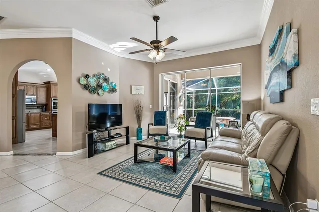 a view of a dining room and livingroom with furniture wooden floor a chandelier