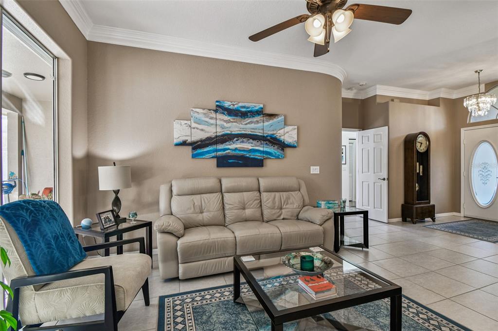 1955 Dunloe Circle Dunedin, FL 34698 - Photo 13 of 94 a living room with furniture a rug and a window
