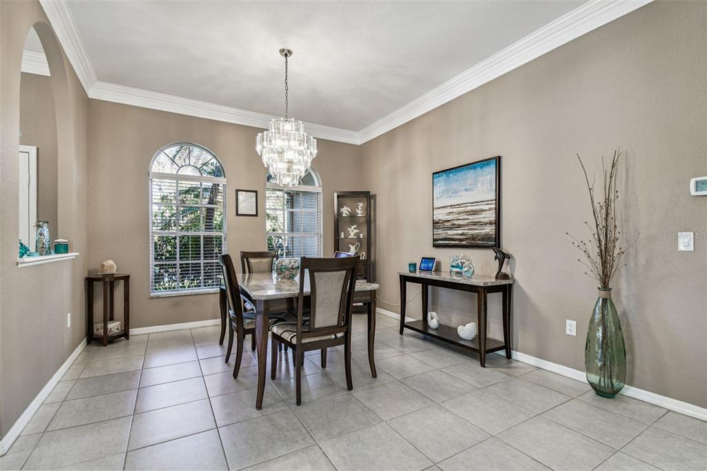 1955 Dunloe Circle Dunedin, FL 34698 - Photo 14 of 94 a view of a dining room with furniture and chandelier