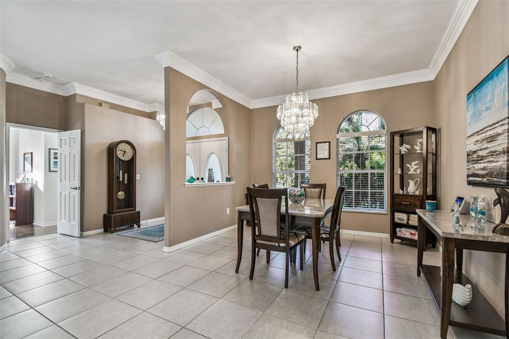 1955 Dunloe Circle Dunedin, FL 34698 - Photo 15 of 94 a view of a dining room with furniture and chandelier