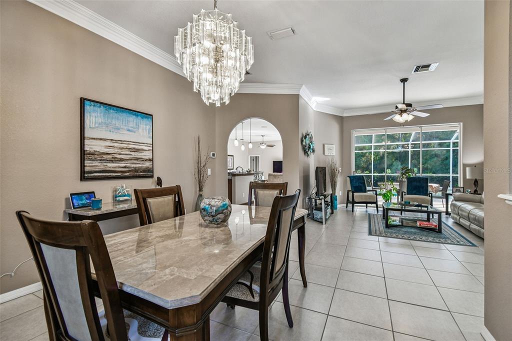 1955 Dunloe Circle Dunedin, FL 34698 - Photo 17 of 94 a view of a dining room with furniture a chandelier and window