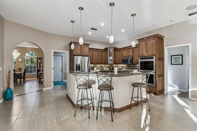a living room with furniture a flat screen tv and a window