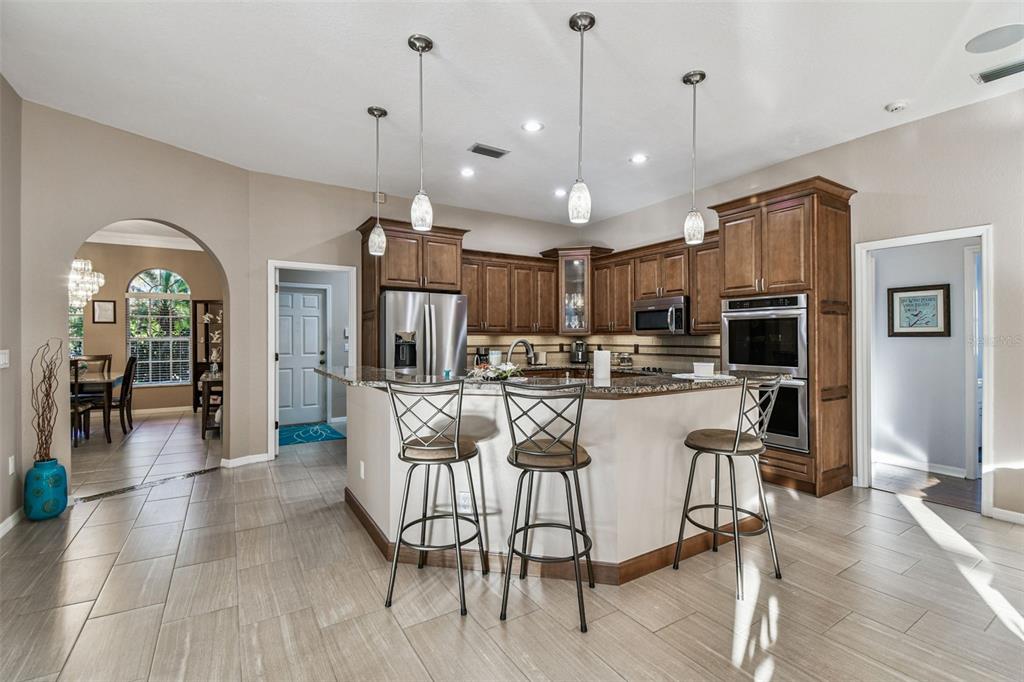 1955 Dunloe Circle Dunedin, FL 34698 - Photo 20 of 94 a view of a dining room and livingroom with furniture wooden floor a chandelier