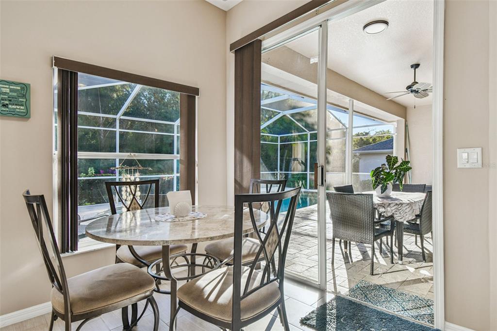 1955 Dunloe Circle Dunedin, FL 34698 - Photo 29 of 94 a view of a dining room with furniture window and outside view