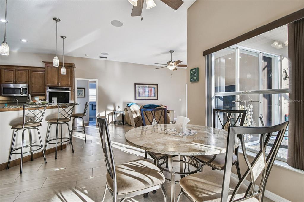 1955 Dunloe Circle Dunedin, FL 34698 - Photo 30 of 94 a view of a dining room and livingroom with furniture wooden floor a chandelier