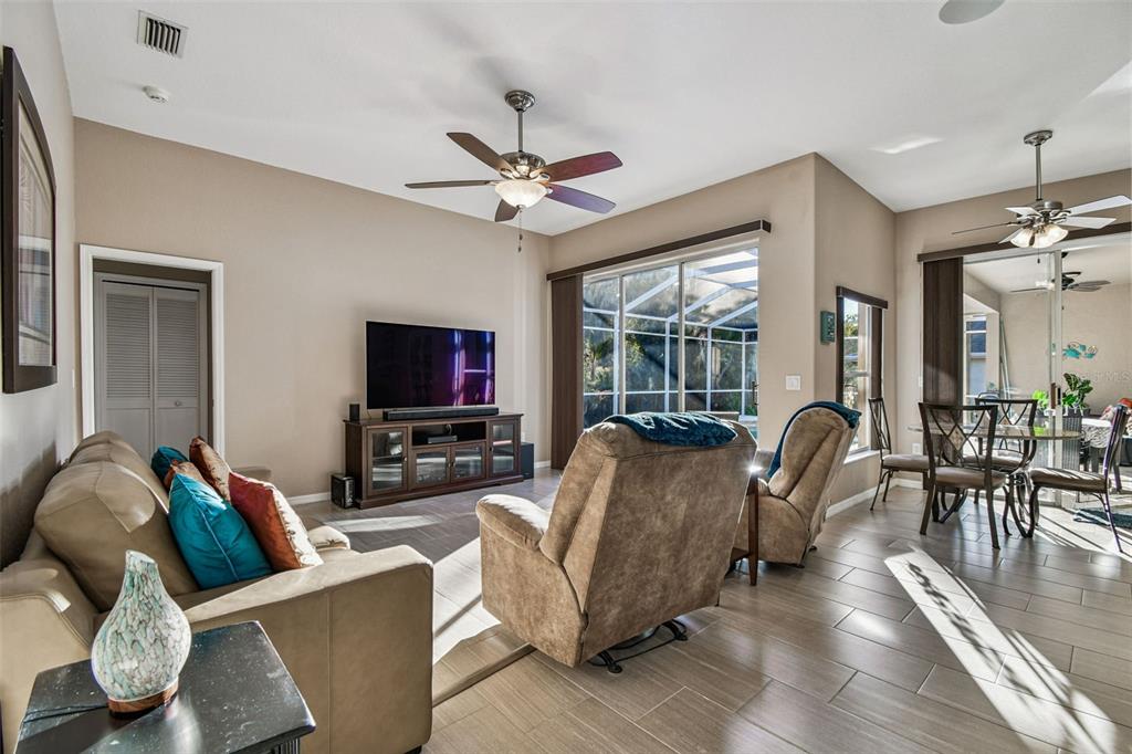 1955 Dunloe Circle Dunedin, FL 34698 - Photo 33 of 94 a living room with furniture and a flat screen tv