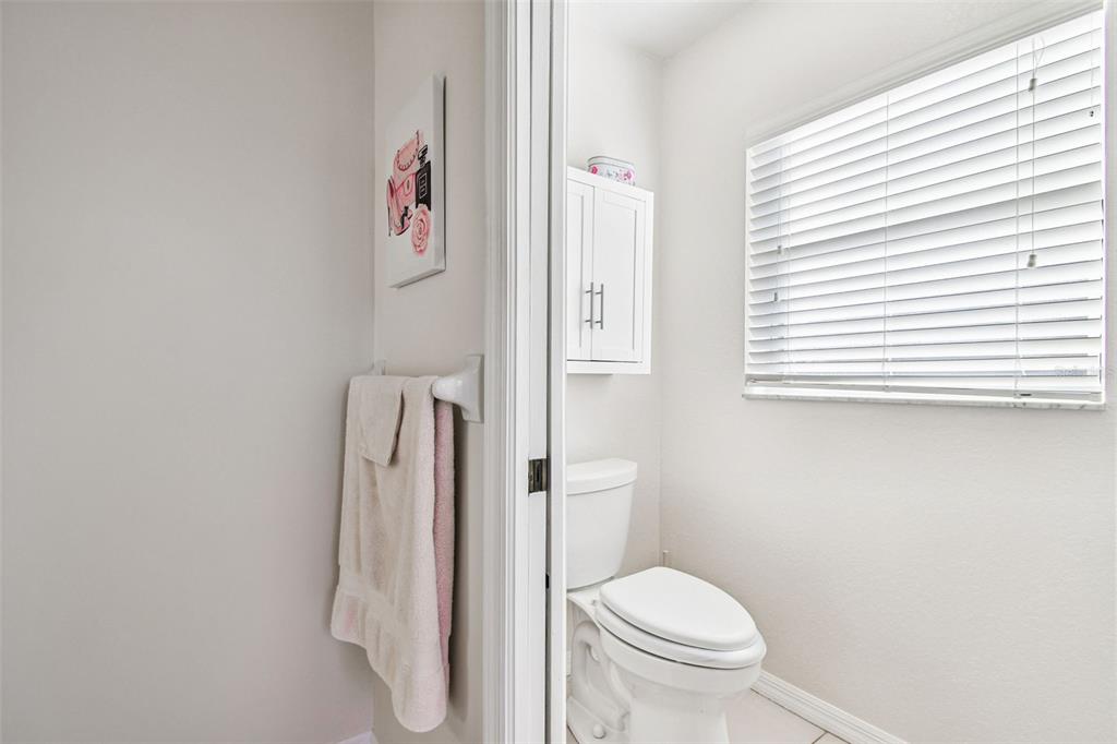 1955 Dunloe Circle Dunedin, FL 34698 - Photo 45 of 94 a white toilet sitting next to a bathroom sink