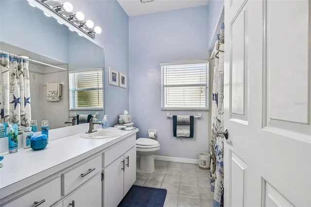 an aerial view of residential houses with outdoor space and lake view