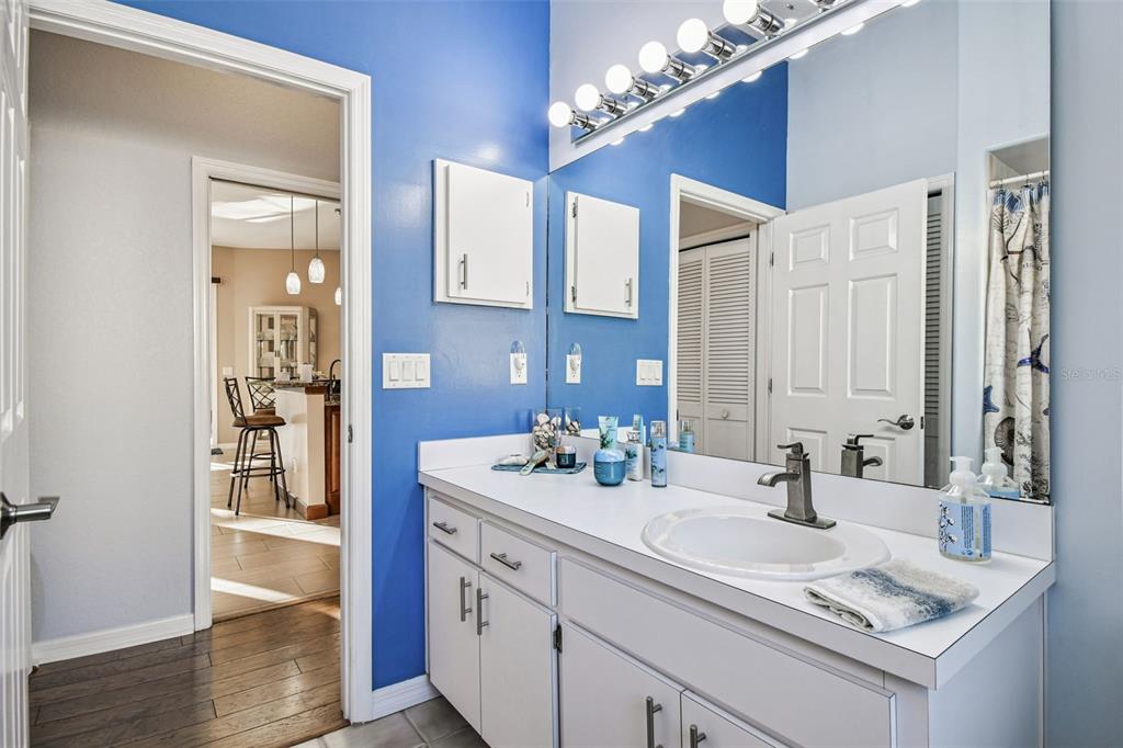 1955 Dunloe Circle Dunedin, FL 34698 - Photo 48 of 94 a bathroom with a sink double vanity and a mirror