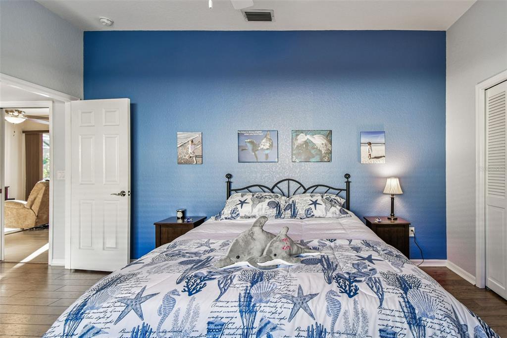 1955 Dunloe Circle Dunedin, FL 34698 - Photo 50 of 94 a bedroom with a bed and painting on the wall